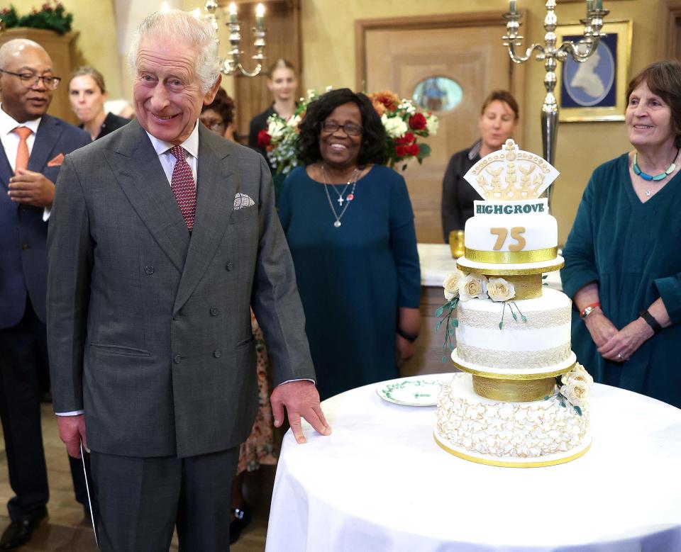 King Charles III prepares to cut a birthday cake as he attends his 75th birthday party at Highgrove House on Nov. 13.