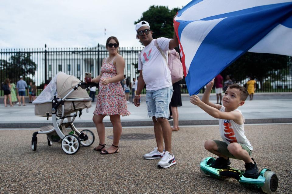 People supporting protests in Cuba gather on Pennsylvania Avenue outside the White House grounds July 13, 2021, in Washington, DC.