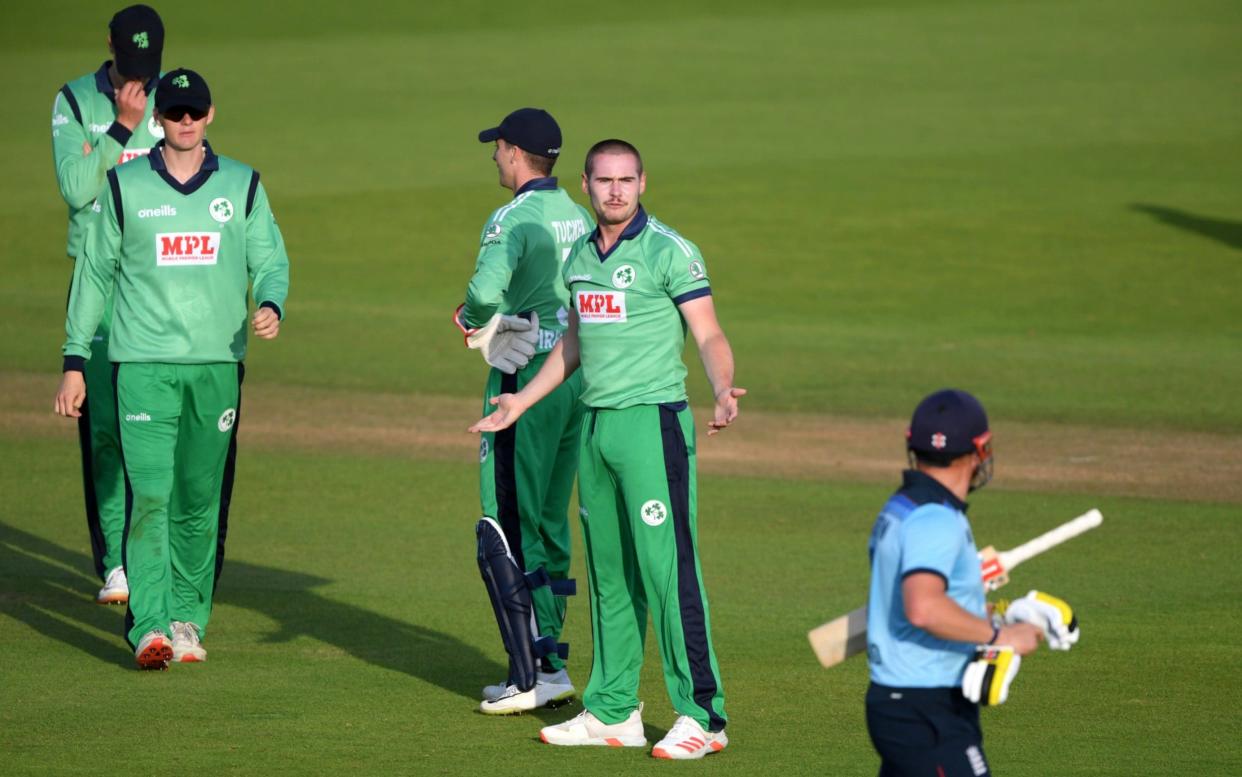 England's Jonny Bairstow with Ireland's Josh Little after losing his wicket , as play resumes behind closed doors following the outbreak of the coronavirus disease.  - REUTERS