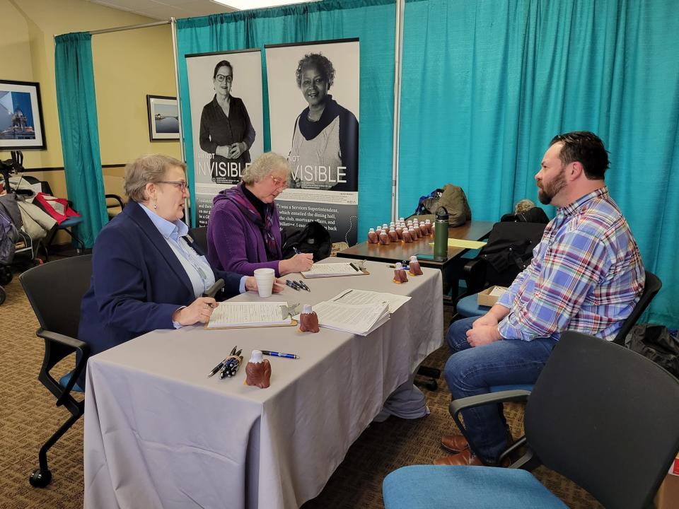 Women veterans complete forms ahead of interviews at the I Am Not Invisible event, as seen, Saturday, Jan. 28.