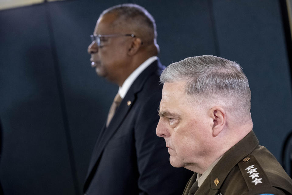 Secretary of Defense Lloyd Austin, left, accompanied by Chairman of the Joint Chiefs, Gen. Mark Milley, right, speaks during a briefing at the Pentagon in Washington, Wednesday, March 15, 2023. (AP Photo/Andrew Harnik)