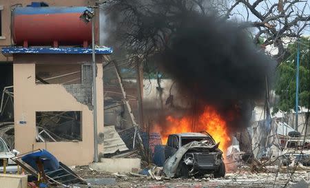 A vehicle burns at the scene of a suicide bomb attack outside Nasahablood hotel in Somalia's capital Mogadishu, June 25, 2016. REUTERS/Feisal Omar