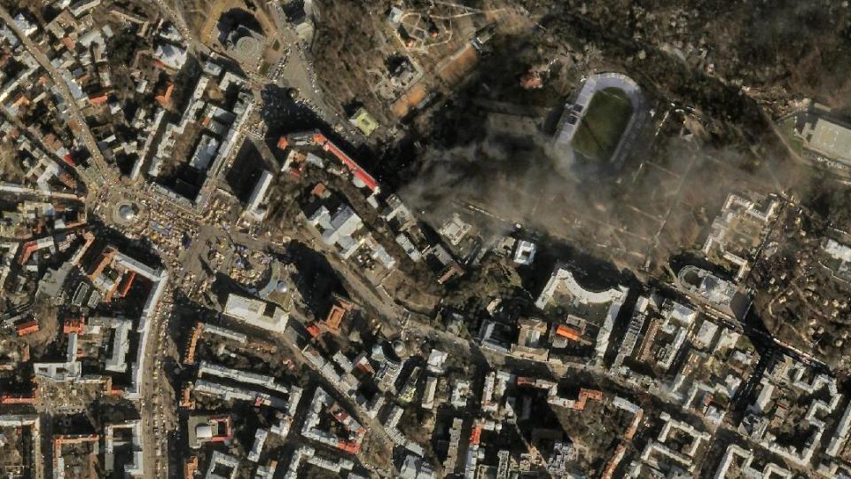 In this satellite image provided by Skybox Imaging and taken by SkySat-1 on Tuesday, Feb. 18, 2014 at 11:10 a.m. local time, smoke rises from the site of anti-government protests, upper center, in Kiev, Ukraine. Thousands of riot police armed with stun grenades and water cannons attacked the sprawling protest camp in the center of Kiev on Tuesday, following a day of street battles that left 18 people dead and hundreds injured. (AP Photo/Skybox Imaging) MANDATORY CREDIT