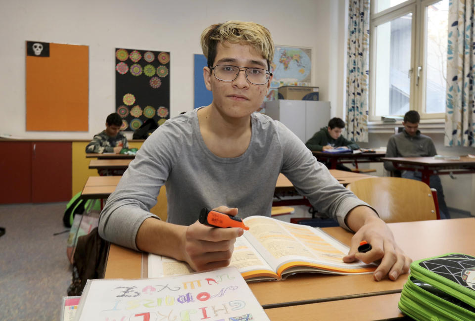 In this Dec. 7, 2018 photo Hassan Husseini from Afghanistan poses for a photograph when attending a clare in a school in Vienna, Austria. Like the nearly 10,000 other school-age children who arrived in Austria during Europe’s largest modern influx of refugees, school is where they must learn to bridge different worlds: one that has shaped their families and identities, and the other where they now hope to prosper in peace. (AP Photo/Ronald Zak)