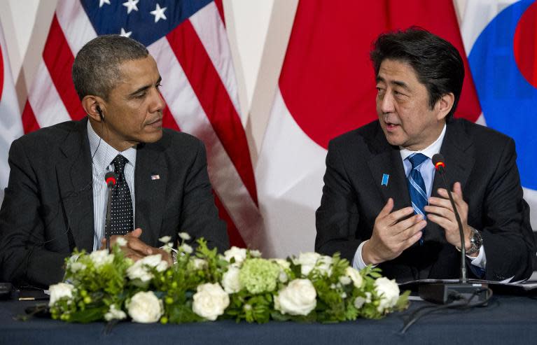 In this file photo, US President Barack Obama (L) is seen listening to Japanese Prime Minister Shinzo Abe during a meeting in The Hague, on March 25, 2014