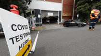 A car leaves a COVD-19 testing station in Melbourne, Australia, Thursday, Feb. 4, 2021. All competition at six Australian Open tuneup events scheduled for Thursday was called off after a worker at one of the tournaments' Melbourne quarantine hotels tested positive for COVID-19.(AP Photo/Hamish Blair)