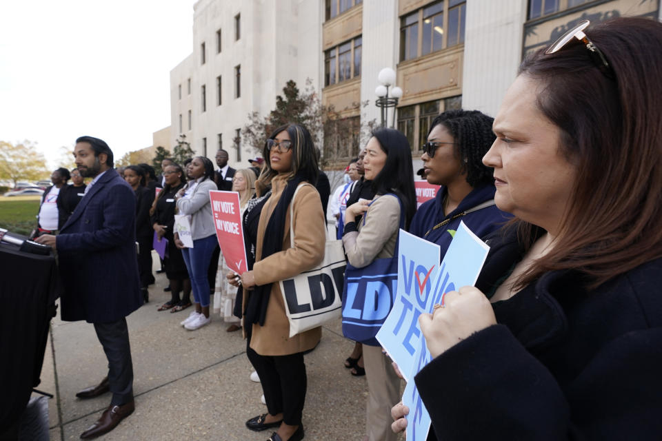 Attorney Greta Kemp Martin, right, joins members of other voting rights groups at a news conference in Jackson, Miss., on Thursday, Dec. 7, 2023, (AP Photo/Rogelio V. Solis)