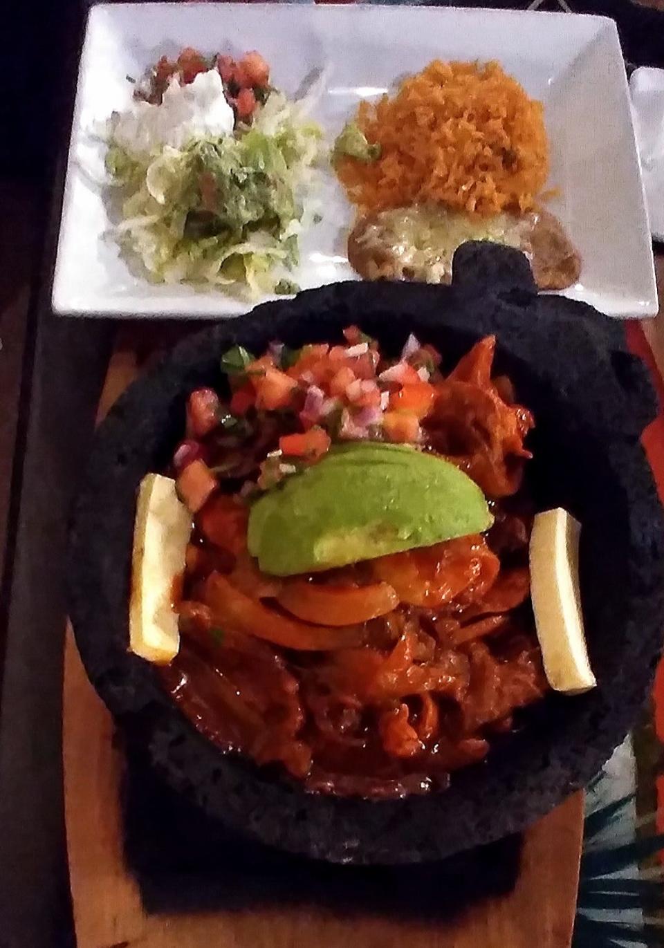 The Molcajete was served in a lava rock brimming with meats, veggies and cheese.