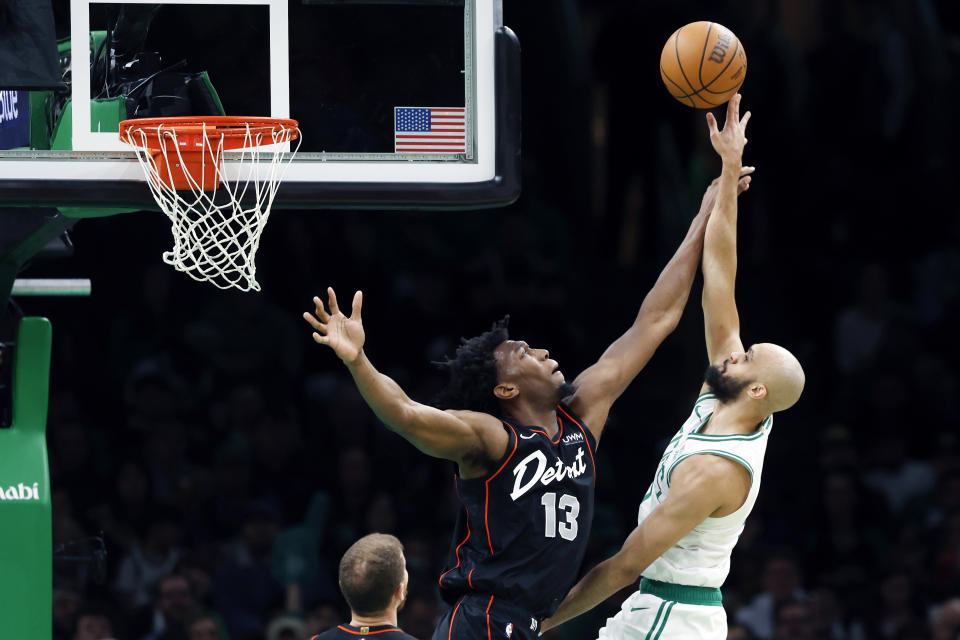 Boston Celtics' Derrick White, right, shoots against Detroit Pistons' James Wiseman (13) during the first half of an NBA basketball game, Monday, March 18, 2024, in Boston. (AP Photo/Michael Dwyer)