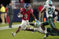 Mississippi running back Jerrion Ealy (9) evades a tackle attempt by Tulane cornerback Jaylon Monroe (9) during the first half of an NCAA college football game Saturday, Sept. 18, 2021, in Oxford, Miss. (AP Photo/Rogelio V. Solis)