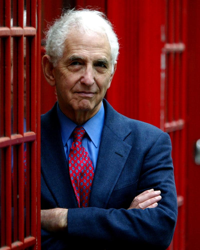 Daniel Ellsberg in 2004 in a red phone booth.