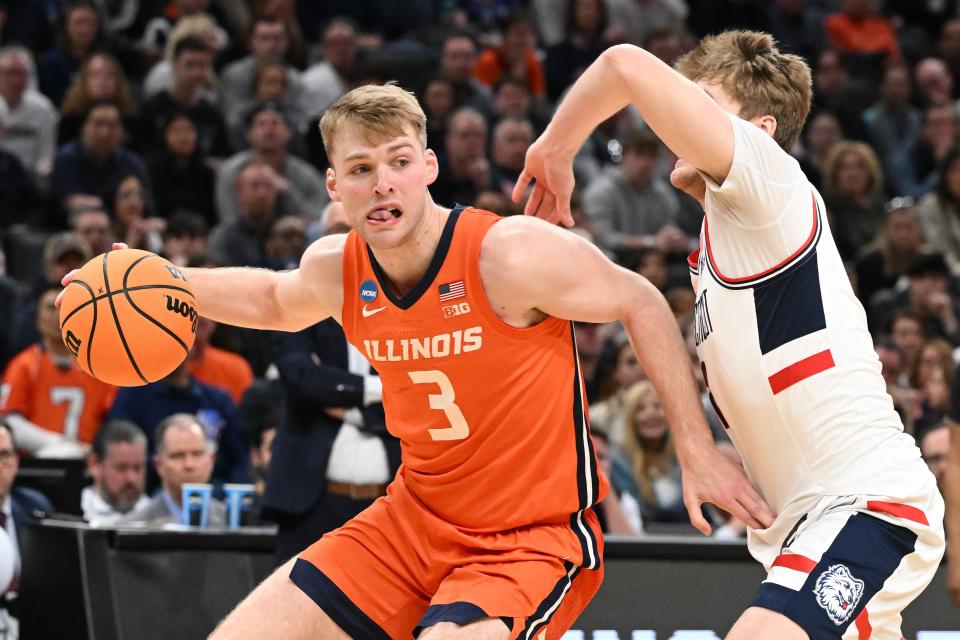 March 30, 2024;  Boston, MA, USA;Illinois Fighting Illini forward Marcus Domask (3) dribbles the ball past Connecticut Huskies guard Cam Spencer (12) in the East Regional finals of the 2024 NCAA Tournament at TD Garden.  Mandatory Credit: Brian Fluharty-USA TODAY Sports