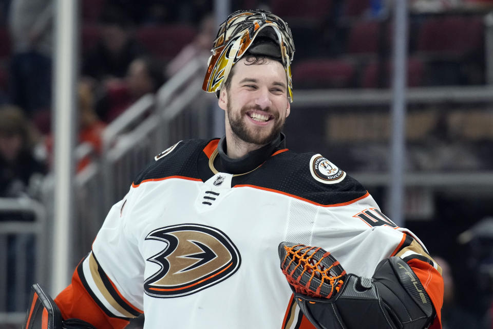 Anaheim Ducks goaltender Anthony Stolarz jokes around with the referees during the second period of the team's NHL hockey game against the Arizona Coyotes, Friday, April 1, 2022, in Glendale, Ariz. (AP Photo/Rick Scuteri)