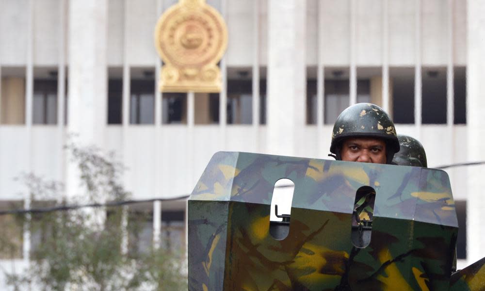 Sri Lankan Special Task Force (STF) members patrol in an armoured vehicle near the supreme court in Colombo on Thursday.