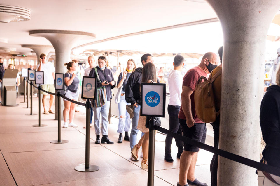 People queue up to sign in at the Opera Bar on December 29, 2021 in Sydney, Australia.