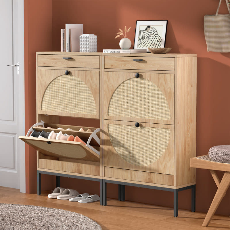 Modern wooden shoe cabinet with two units; each unit has one open tilt-out drawer displaying neatly organized shoes. Decorative items are on top of the cabinet