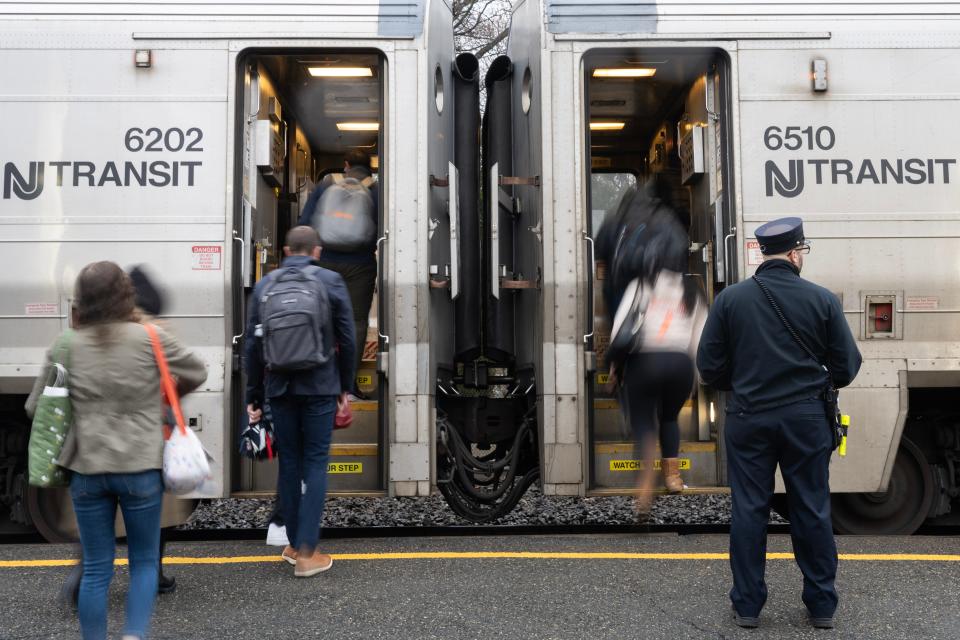 A conductor waits for passengers to board an NJ Transit train at the Clifton Station on Thursday April 11, 2024.