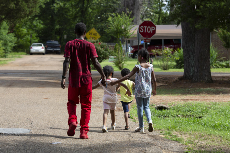 Joshua K. Love walks home with his nieces and a nephew after a game of basketball in Greenwood, Miss., Saturday, June 8, 2019. (AP Photo/Wong Maye-E)