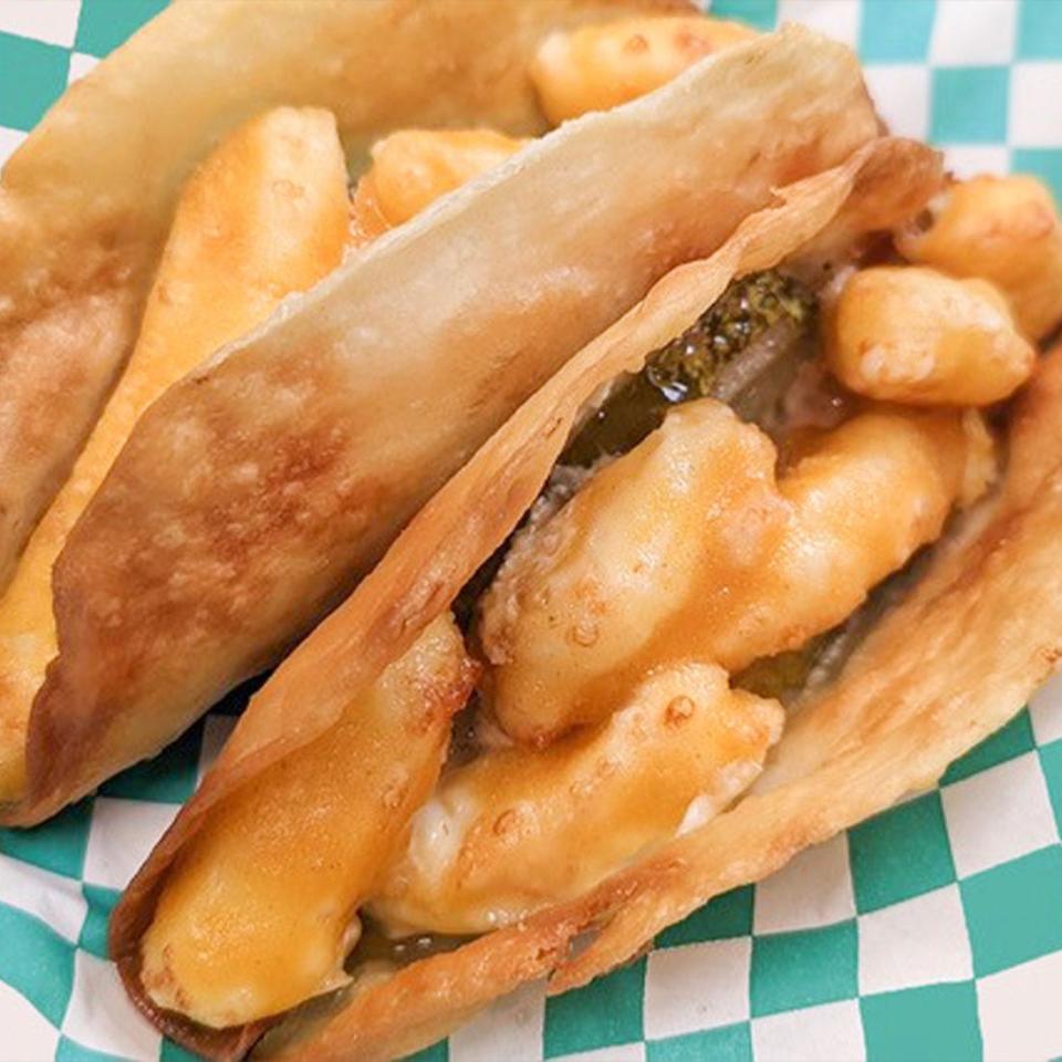 Fried Pickle Cheese Curd Tacos, completely deep-fried, have pickles, cream cheese and white cheddar cheese curds in a crispy taco shell. They are topped with raspberry chipotle sauce and fresh greens. They're from Richie’s.