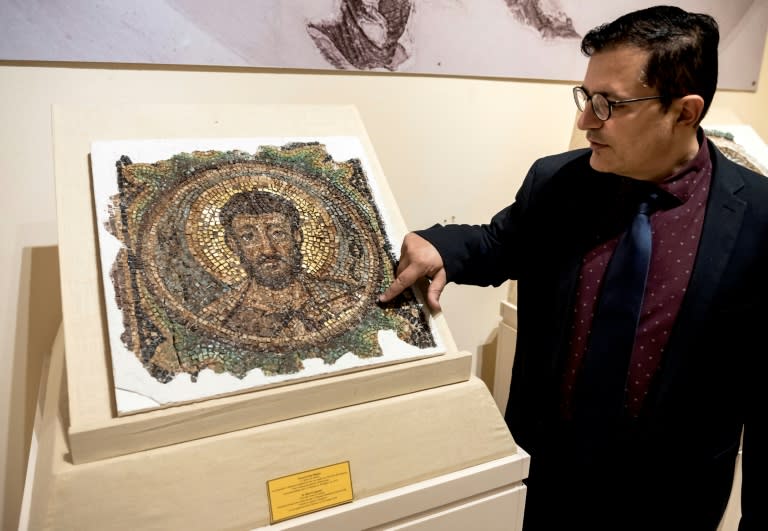 Director of the Cyprus Byzantine Museum Ioannis Eliades shows a centuries-old mosaic of Saint Mark in Nicosia on November 21, 2018