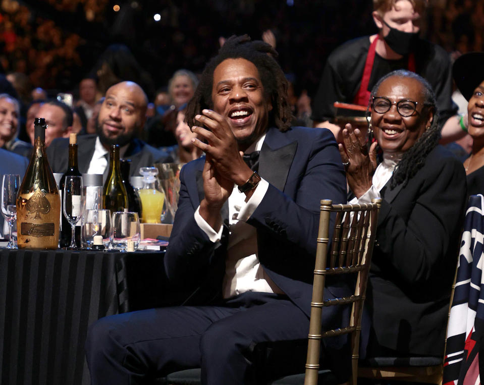 American rapper Jay-Z clapping and sitting next to his mother at the Rock & Roll Hall of Fame.