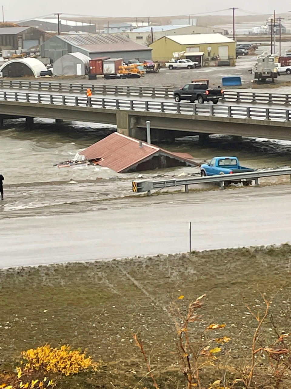 FILE - A home that was knocked off its foundation floats down Snake River during a severe storm in Nome, Alaska, is caught under a bridge on, Sept. 17, 2022. After the remnants of a rare typhoon caused extensive damage along Alaska's western coast last fall, the U.S. government stepped in to help residents, largely Alaska Natives, recovery financially. (AP Photo/Peggy Fagerstrom, File)