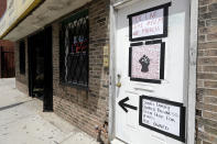 FILE - In this June 5, 2020, file photo, signs supporting Black Lives Matter are displayed at the front door of a residence in Wicker Park in Chicago. The Black Lives Matter Global Network Foundation, which grew out of the creation of the Black Lives Matter movement, is formally expanding a $3 million financial relief fund that it quietly launched in February 2021, to help people struggling to make ends meet during the ongoing coronavirus pandemic. (AP Photo/Nam Y. Huh, File)