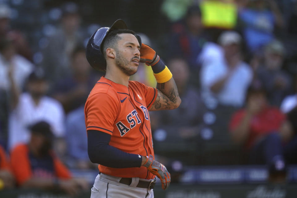 Houston Astros' Carlos Correa stands at home and pulls off his batting helmet after striking out looking against the Seattle Mariners to end the top of the eighth inning of a baseball game Wednesday, Sept. 1, 2021, in Seattle. (AP Photo/Elaine Thompson)