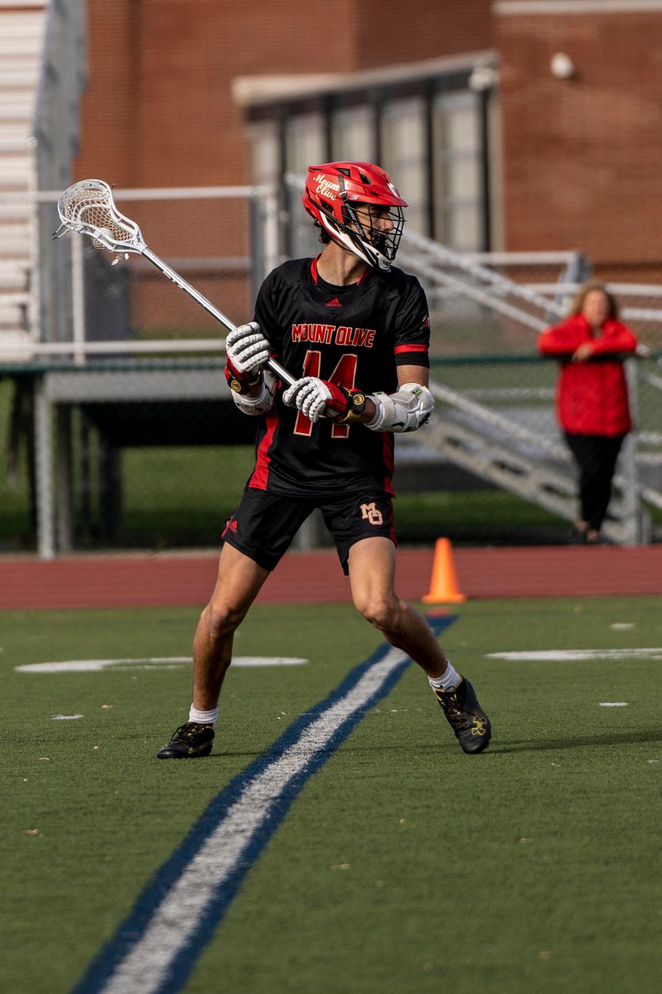 MO #14 Jack Mullery with the ball. Madison hosts Mount Olive in Morris County lacrosse tournament on Tuesday, May 2, 2023. 