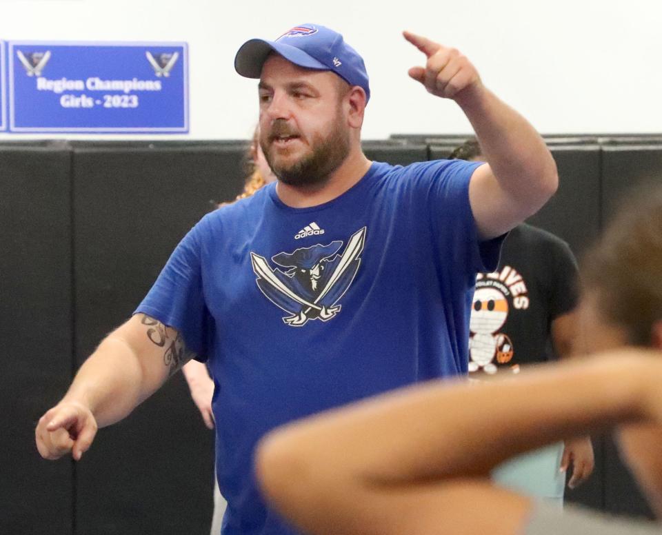 Matanzas coach Mike Fries points to spots on the mat and calls out names as the team runs drills during practice, Tuesday, Nov. 21, 2023.