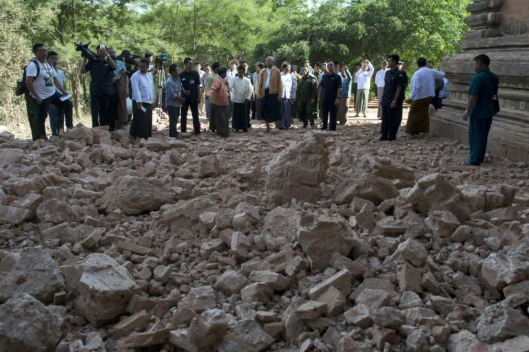 Myanmar president Htin Kyaw (C) and goverment officals inspect the damaged ancient pagoda of Sulamani the day after a 6.8 magnitude earthquake hit Bagan, on August 25, 2016