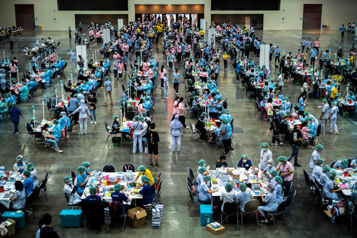 High school students between the ages of 12-17 receive the first dose of Pfizer-BioNTech vaccine against the coronavirus disease (COVID-19) ahead of schools reopening in November, at a convention hall in the outskirts of Bangkok, Thailand, October 15, 2021. REUTERS/Athit Perawongmetha