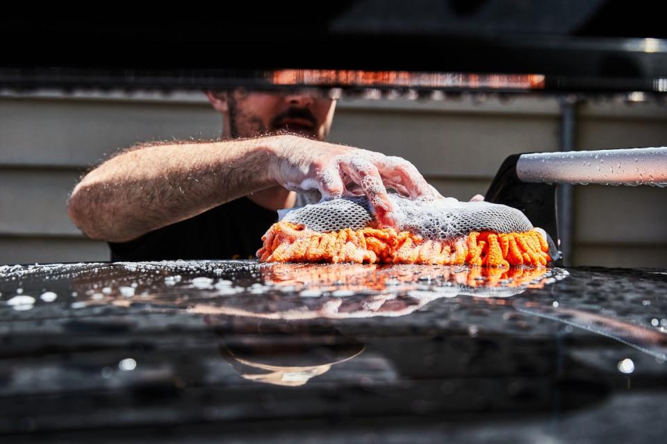 a person with a beard and mustache holding a large piece of meat