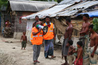 A Cyclone Preparedness Programme (CPP) volunteer uses a megaphone to urge residents to evacuate to shelters ahead of the expected landfall of cyclone Amphan in Khulna on May 19, 2020. (Photo by KAZI SHANTO/AFP via Getty Images)