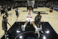 Atlanta Hawks forward John Collins (20) scores over San Antonio Spurs guard DeMar DeRozan (10) during the first half of an NBA basketball game in San Antonio, Friday, Jan. 17, 2020. (AP Photo/Eric Gay)