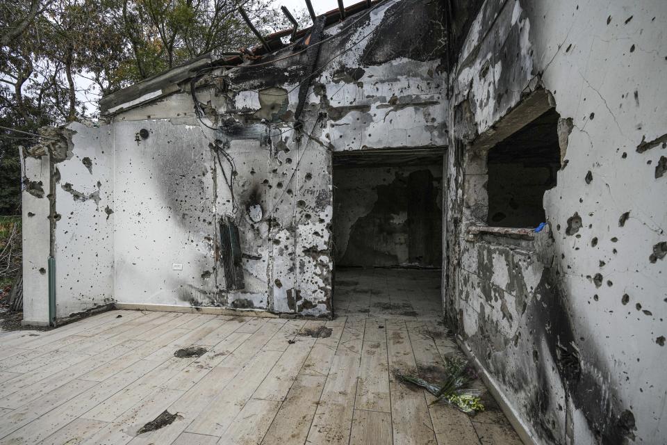 A battle-scarred home in Kibbutz Be'eri, an Israeli communal farm on the Gaza border, is seen Thursday, Jan. 11, 2024. Hamas held more than a dozen hostages in the home when it overran southern Israel on Oct. 7. At the end of an hours-long battle between the militants and Israeli forces, only two hostages survived, and relatives of the slain hostages now demand to know if their loved ones were killed by friendly fire from an Israeli tank. (AP Photo/Tsafrir Abayov)