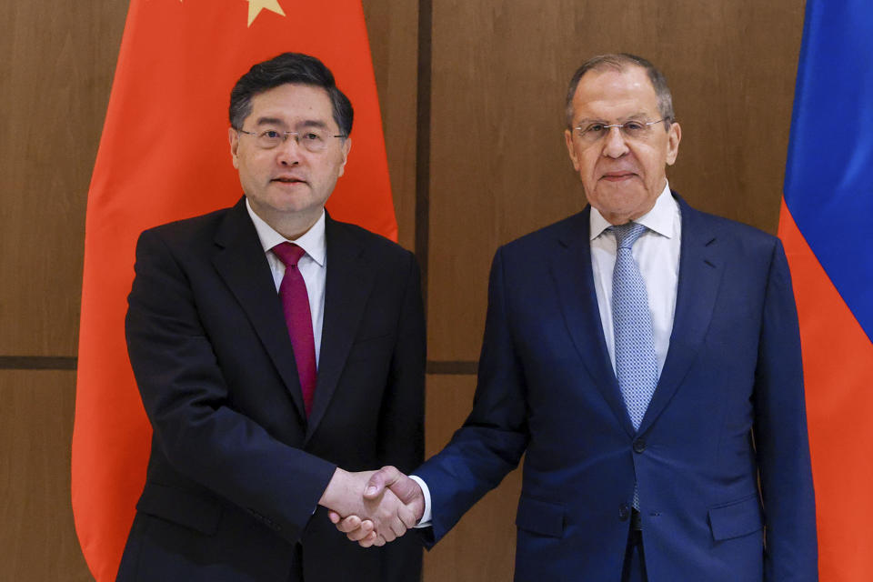 In this handout photo released by Russian Foreign Ministry Press Service, Russian Foreign Minister Sergey Lavrov, right, and Chinese Foreign Minister Qin Gang pose for photo during their meeting in Samarkand, Uzbekistan, Thursday, April 13, 2023. (Russian Foreign Ministry Press Service via AP)