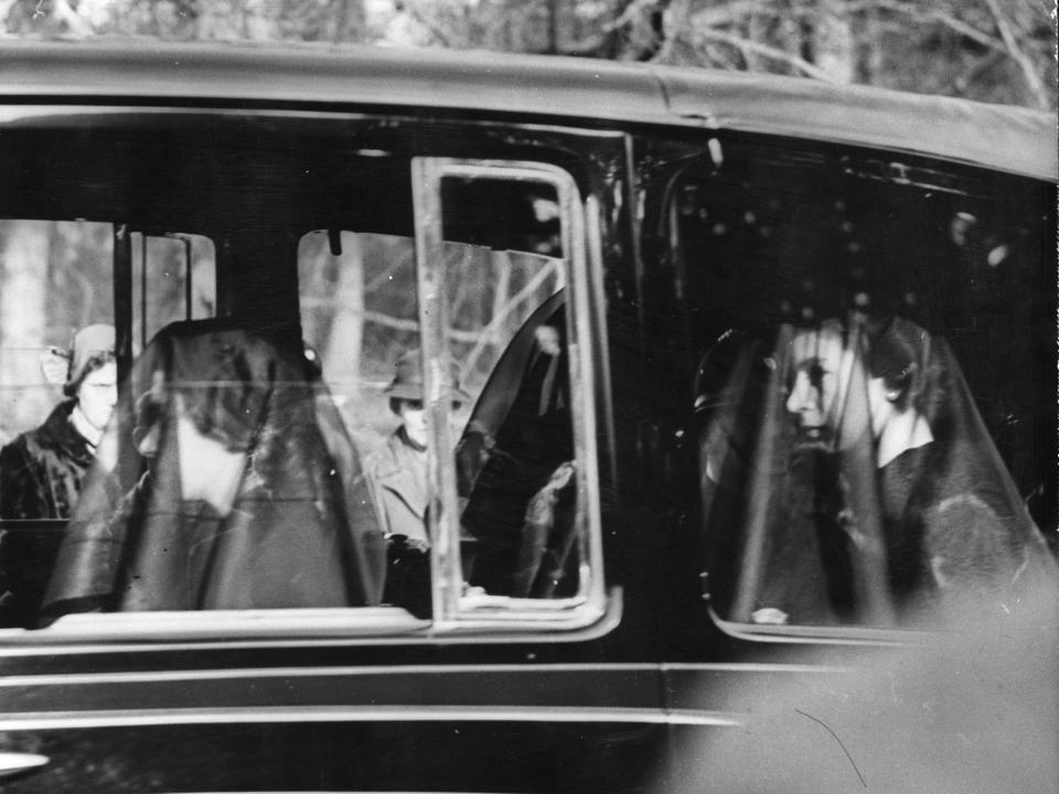 Queen Elizabeth and Princess Margaret wearing black veils in the mourning cortege of their late father, King George VI on February 11, 1952.