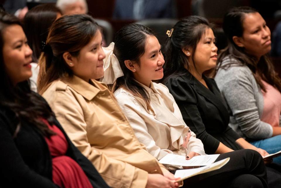 Immigrants to the United States listen as U.S. District Judge Taylor McNeel leads their naturalization ceremony at Dan M. Russell Courthouse in Gulfport on Thursday, Oct. 19, 2023.