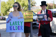 Supporters of the California recall of Gov. Gavin Newsom and Republican candidate Larry Elder hold signs outside of a debate by Republican gubernatorial candidates at the Richard Nixon Presidential Library Wednesday, Aug. 4, 2021, in Yorba Linda, Calif. Newsom faces a Sept. 14 recall election that could remove him from office. (AP Photo/Marcio Jose Sanchez)