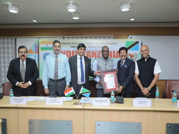 High Commissioner of Tanzania HE Baraka Luanda along with other delegates presenting the Certificate of Appointment to Dr. J. Shrenik Nahar, IATC Trade Commissioner for Tanzania