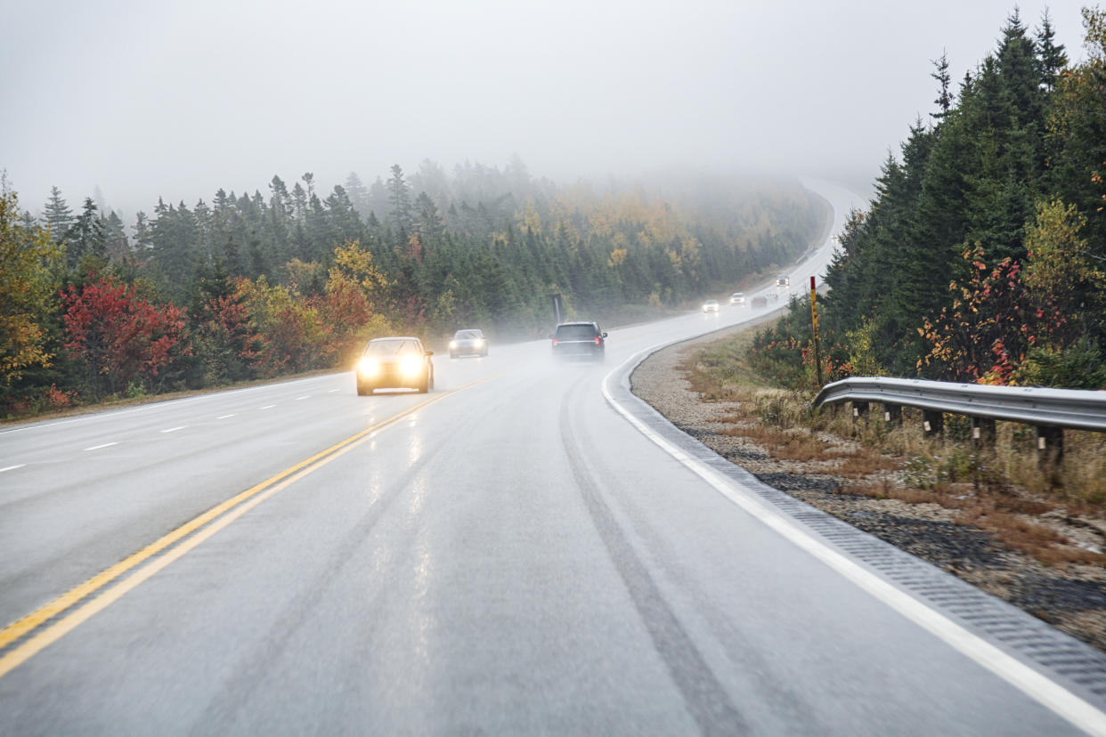 Travelling this spring? Best fog lights and headlights for safe driving — all from eBay, Car driver's point of view driving up a winding, wet, slippery uphill grade on a Canadian highway on a trip to Peggy's Cove in Nova Scotia, Canada during a foggy mid-October rain storm.