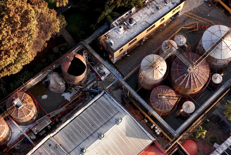 Aerial view showing damages at the Jose Cuervo tequila factory on July 24, 2024, a day after an explosion occurred during maintenance works at the facility in the Tequila municipality, Jalisco State, Mexico. The explosion at the factory producing Jose Cuervo tequila killed at least five people on July 23, local authorities said. It was not yet known what caused the blast, with the company saying it happened during maintenance work. It impacted four containers with a capacity of 219,000 litres each, two of which collapsed, said Victor Hugo Roldan, state director of civil protection. (Photo by ULISES RUIZ / AFP) (Photo by ULISES RUIZ/AFP via Getty Images)