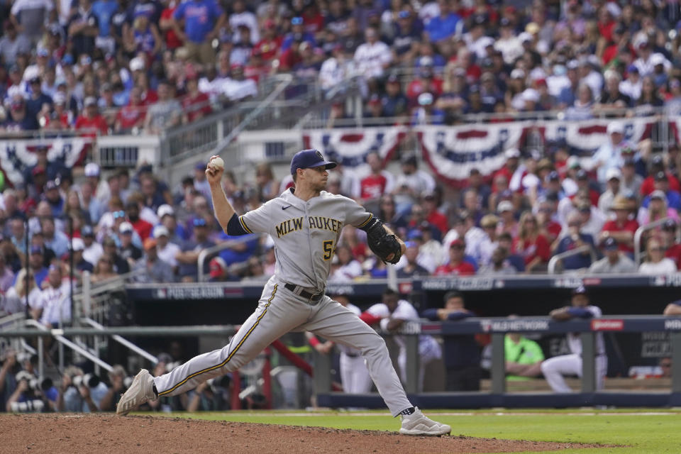 Milwaukee Brewers relief pitcher Jake Cousins (54) deliveres against the Atlanta Braves during the eighth inning of Game 3 of a baseball National League Division Series, Monday, Oct. 11, 2021, in Atlanta. (AP Photo/Brynn Anderson)