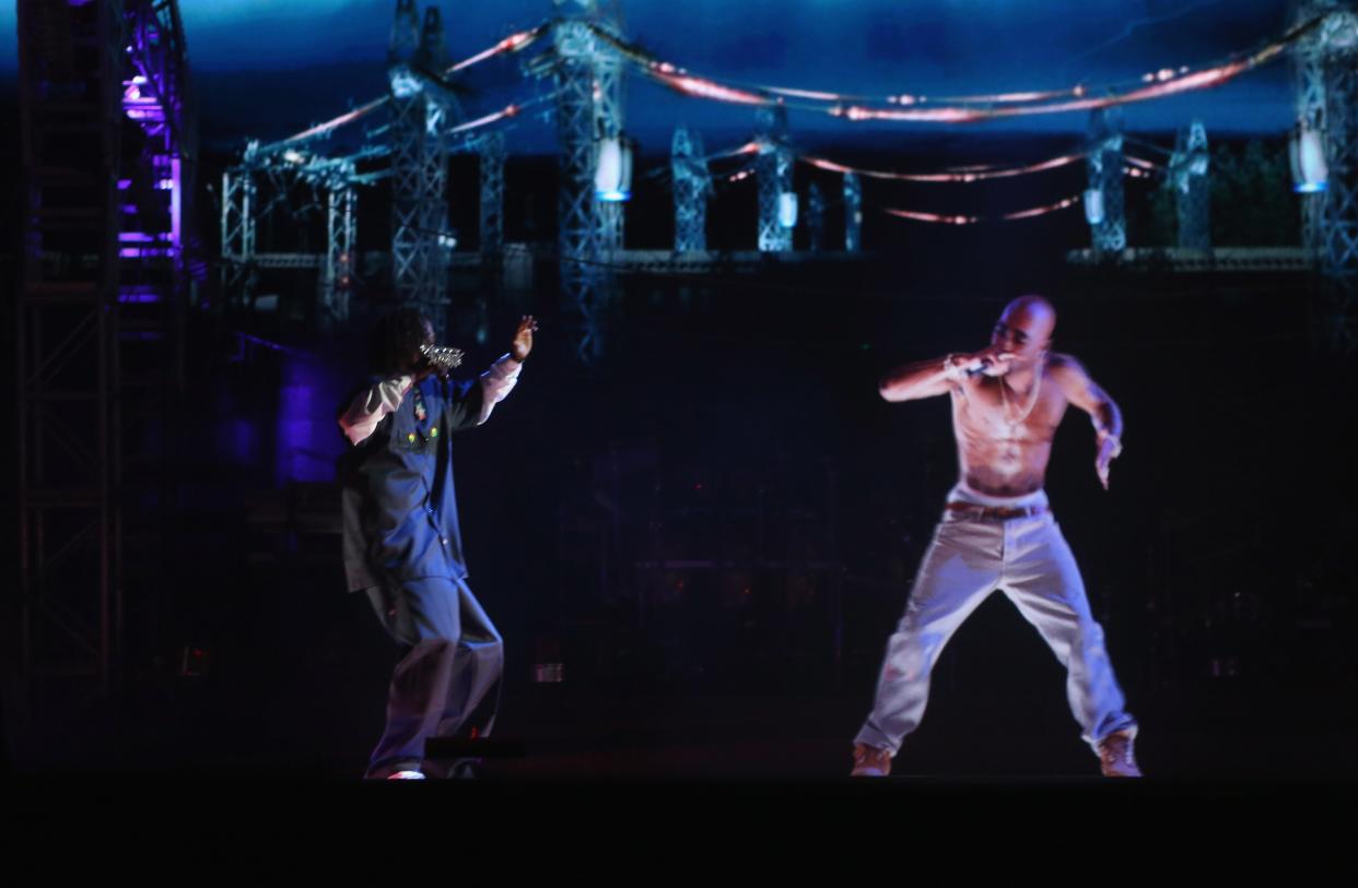 Rapper Snoop Dogg (L) and a hologram of deceased Tupac Shakur perform onstage during day 3 of the 2012 Coachella Valley Music & Arts Festival at the Empire Polo Field on April 15, 2012 in Indio, California. (Getty)