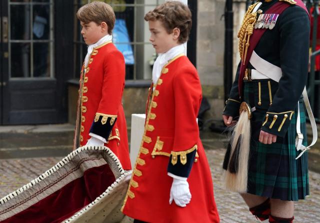 Prince George of Wales (L), one of four Pages of Honour, arrives at Westminster Abbey (POOL/AFP via Getty Images)