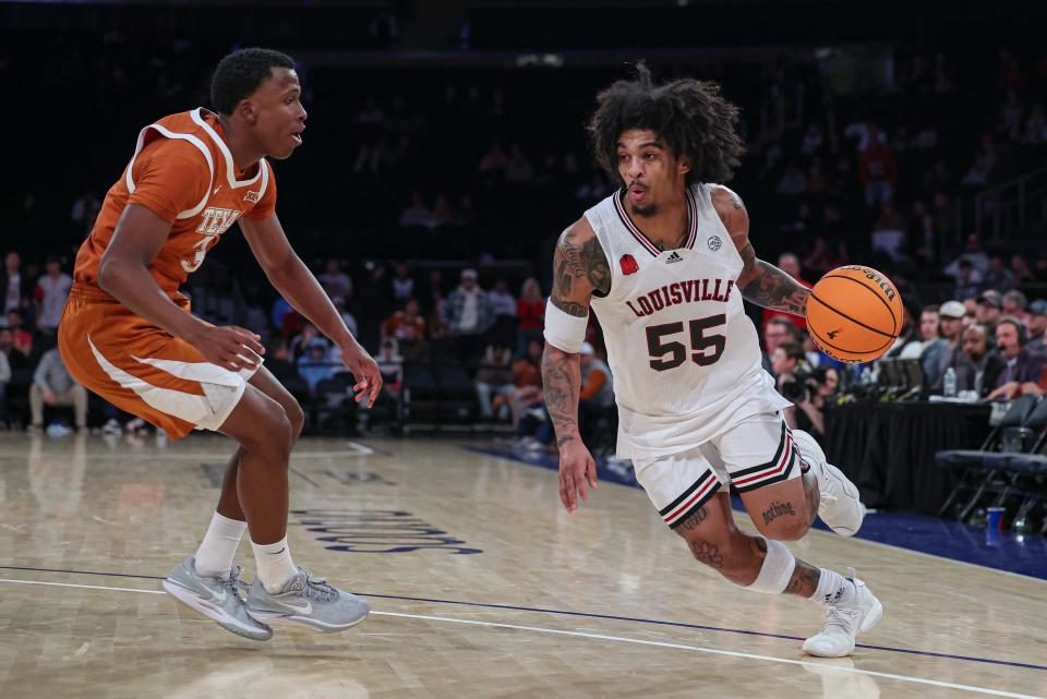 Nov 19, 2023; New York, New York, USA; Louisville Cardinals guard Skyy Clark (55) dribbles against Texas Longhorns guard Max Abmas (3) during the second half at Madison Square Garden. Mandatory Credit: Vincent Carchietta-USA TODAY Sports
