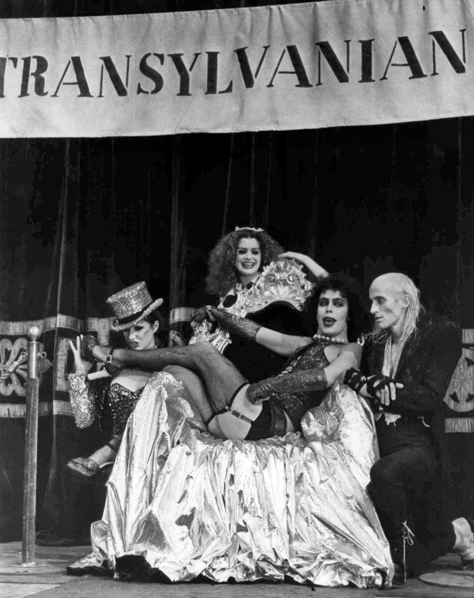 Tim Curry, center, who plays Frank N. Furter, sings "Sweet Transvestite" with Little Nell, left, who plays Columbia, Patricia Quinn, who plays Magenta and Richard O'Brien, right, as Riff Raff, in the 1975 film "The Rocky Horror Picture Show."