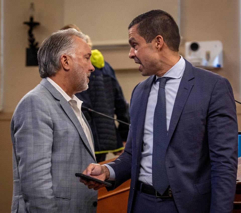 Manny Chamizo, left, speaks to Coral Gables Mayor Vince Lago during a break in the City Commission meeting on Feb. 13, 2024. Lago previously appointed Chamizo to the city’s Waterway Advisory Board.