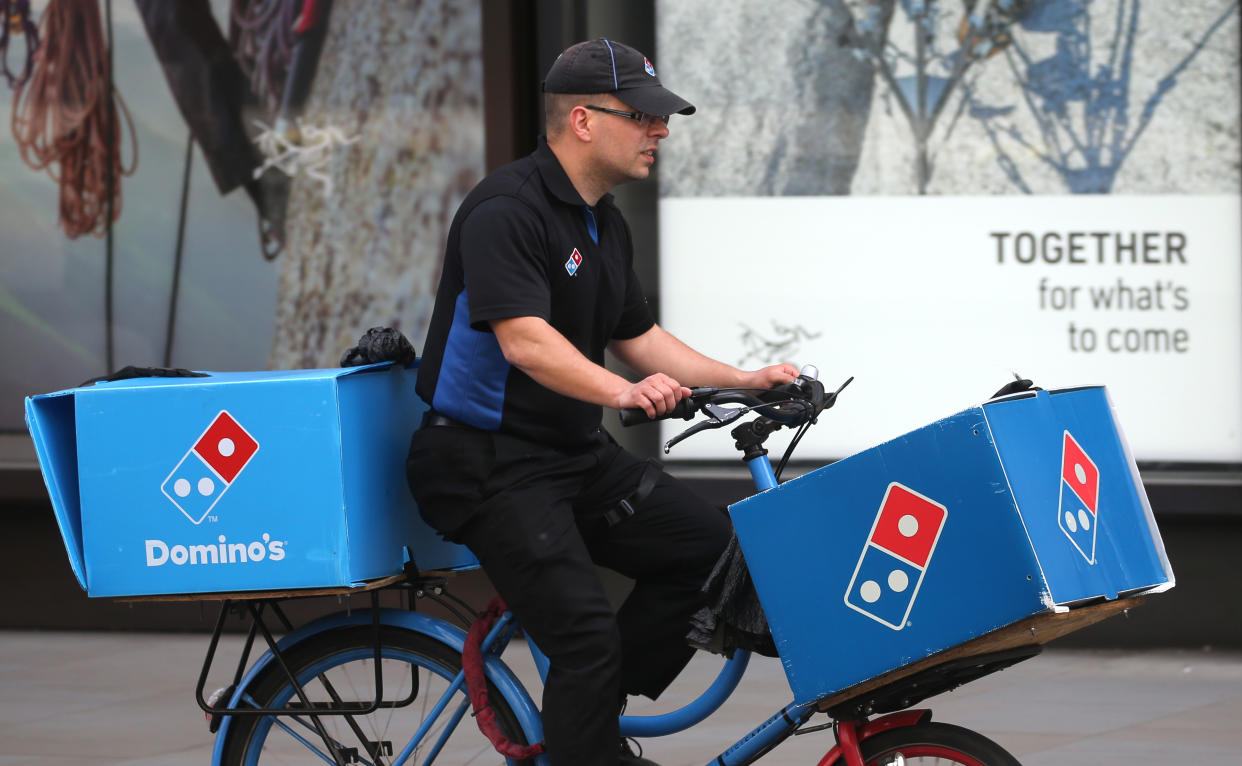 A Domino's Pizza delivery cyclist rides in central London, as the UK continues in lockdown to help curb the spread of the coronavirus. Issue date: Monday April 20, 2020.